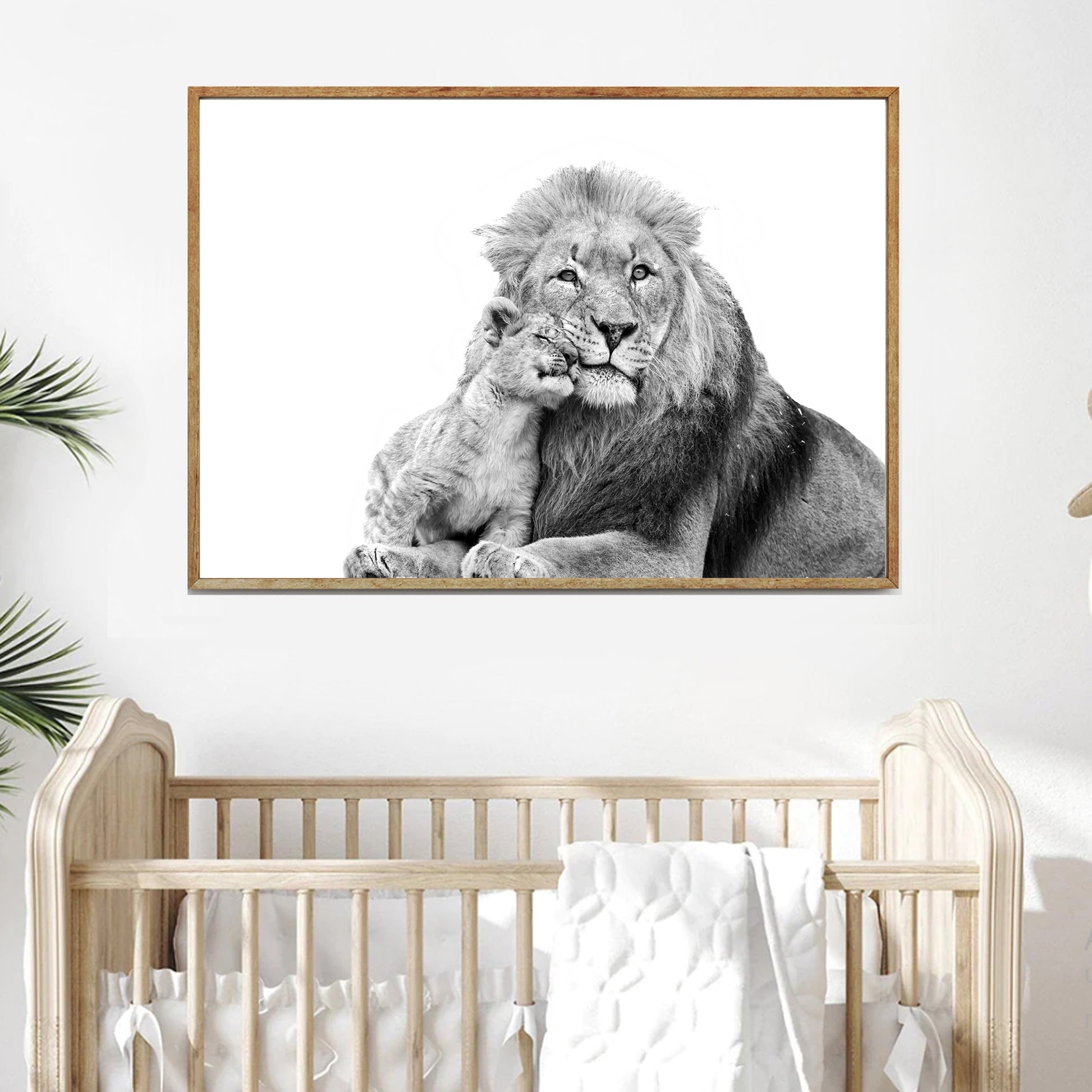 A print of two lions hangs on the wall in the nursery.