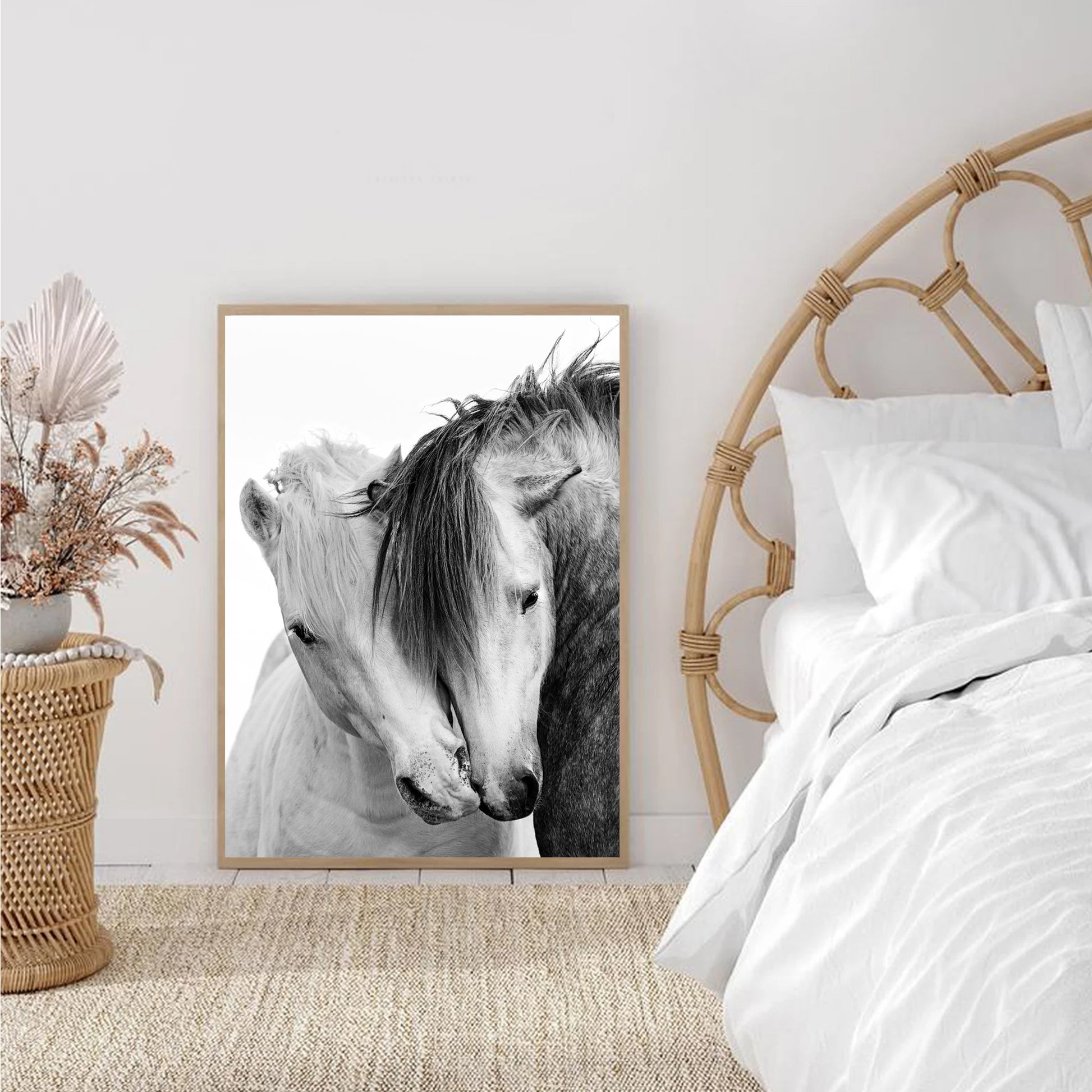 Two kissing horses print stands against the wall in the bedroom.