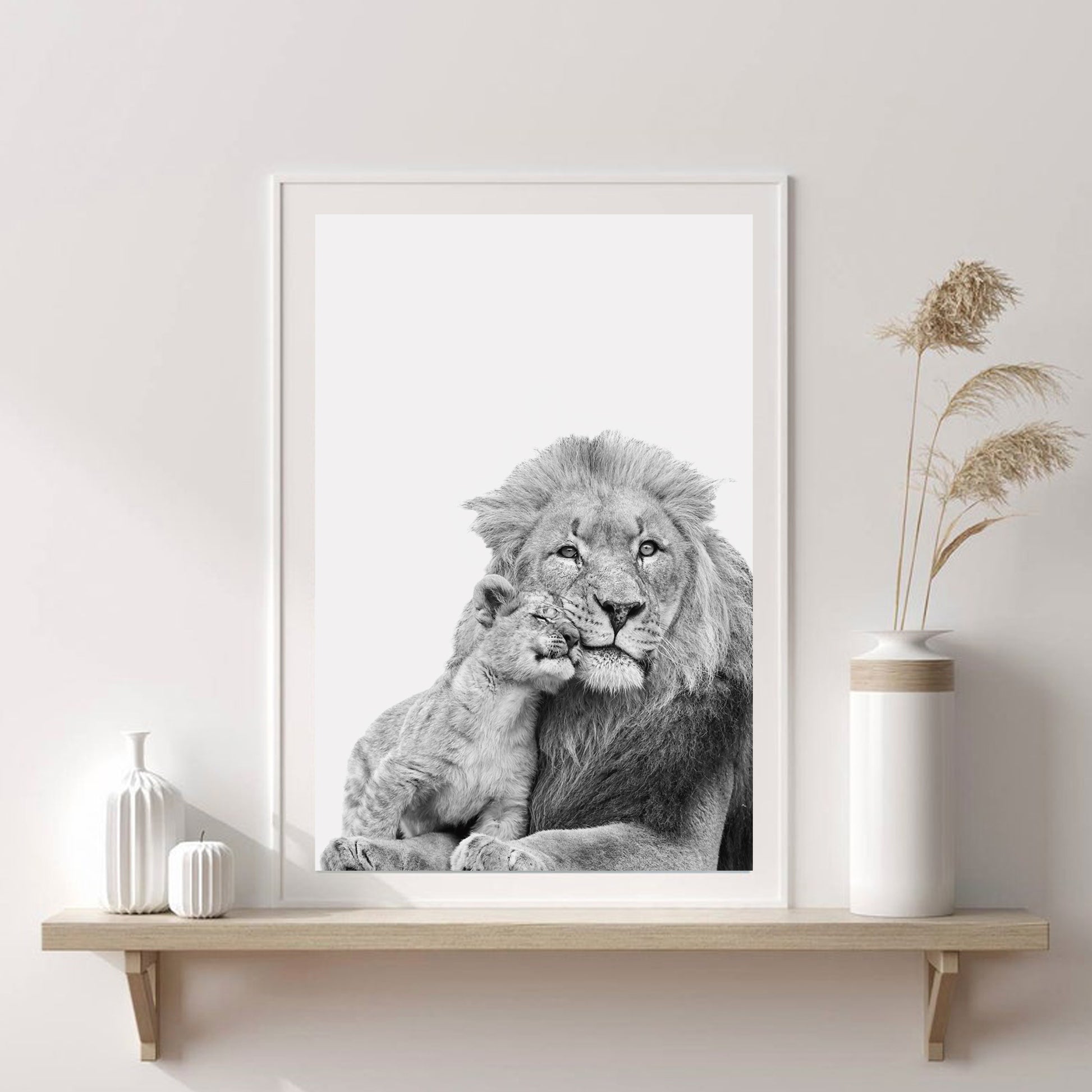 Lion with cub print against a white wall.