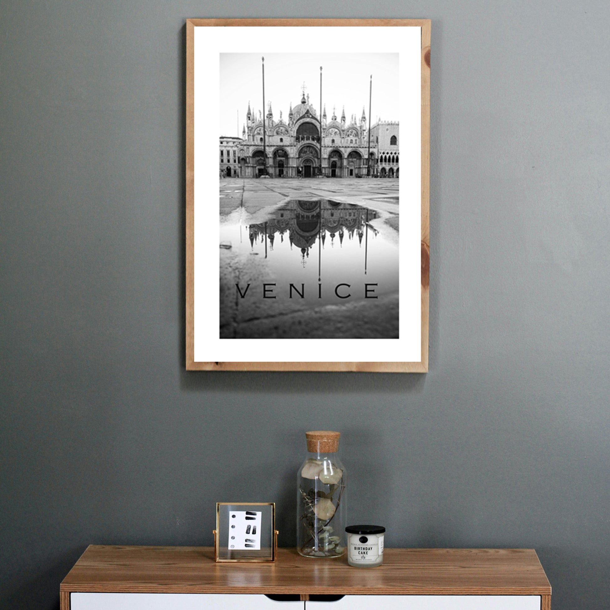 Venice poster on grey wall.