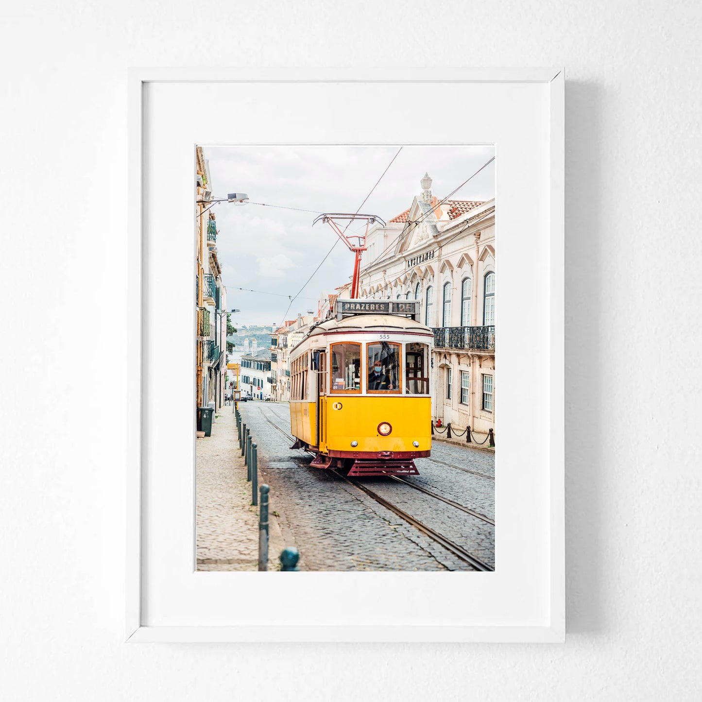 Yellow tram print in white frame.