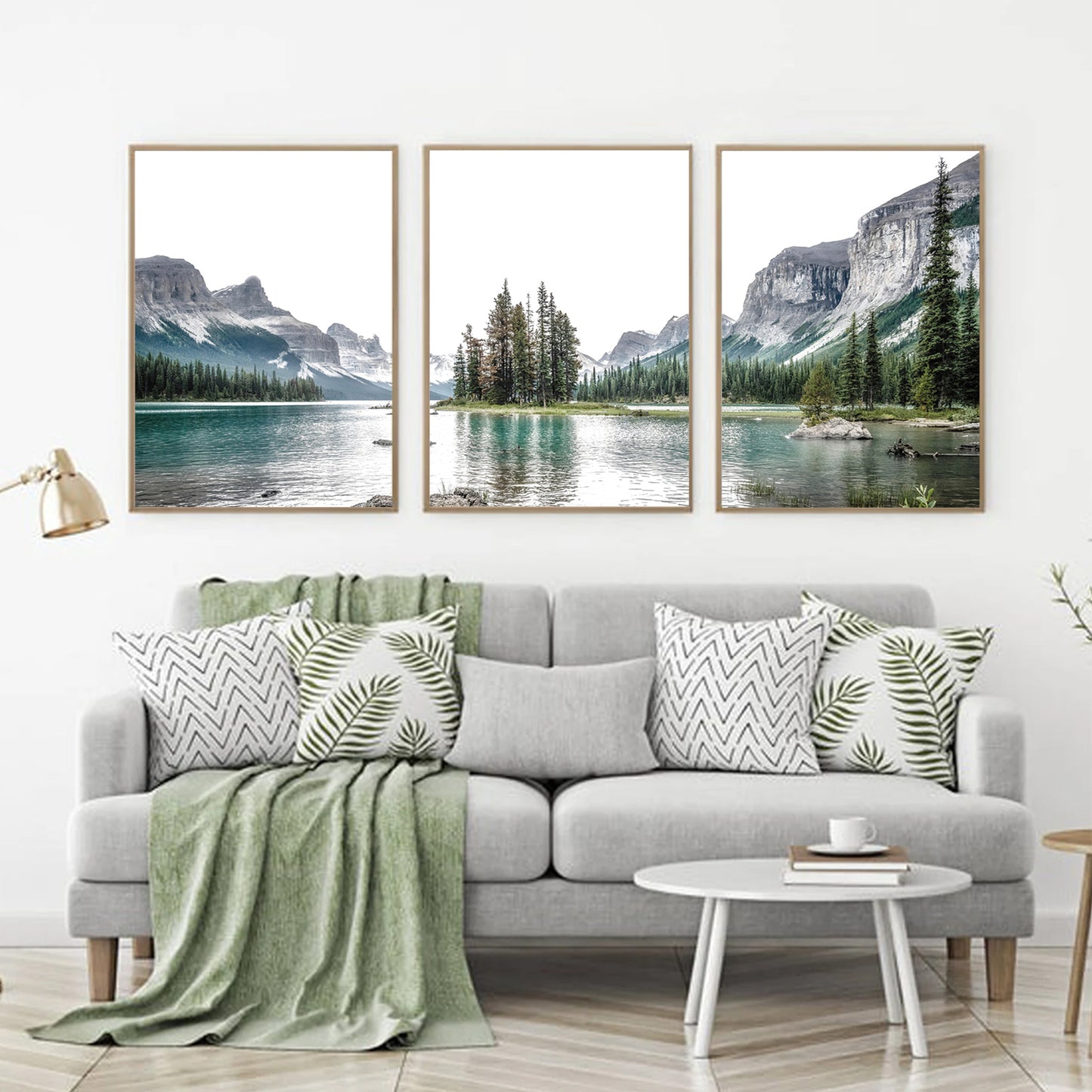 Mountain lake wall art in a light interior with green shades.