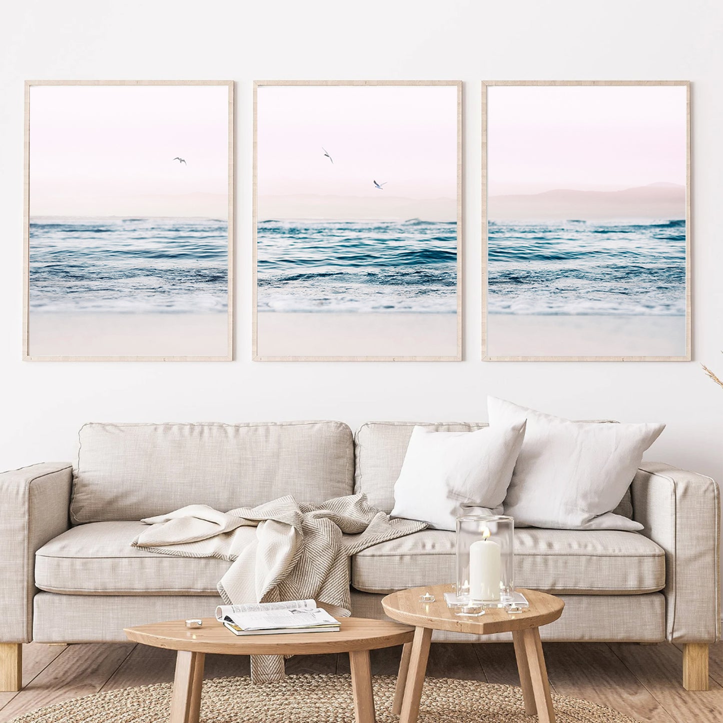 Ocean and seagulls wall art in wood color frames above the sofa.