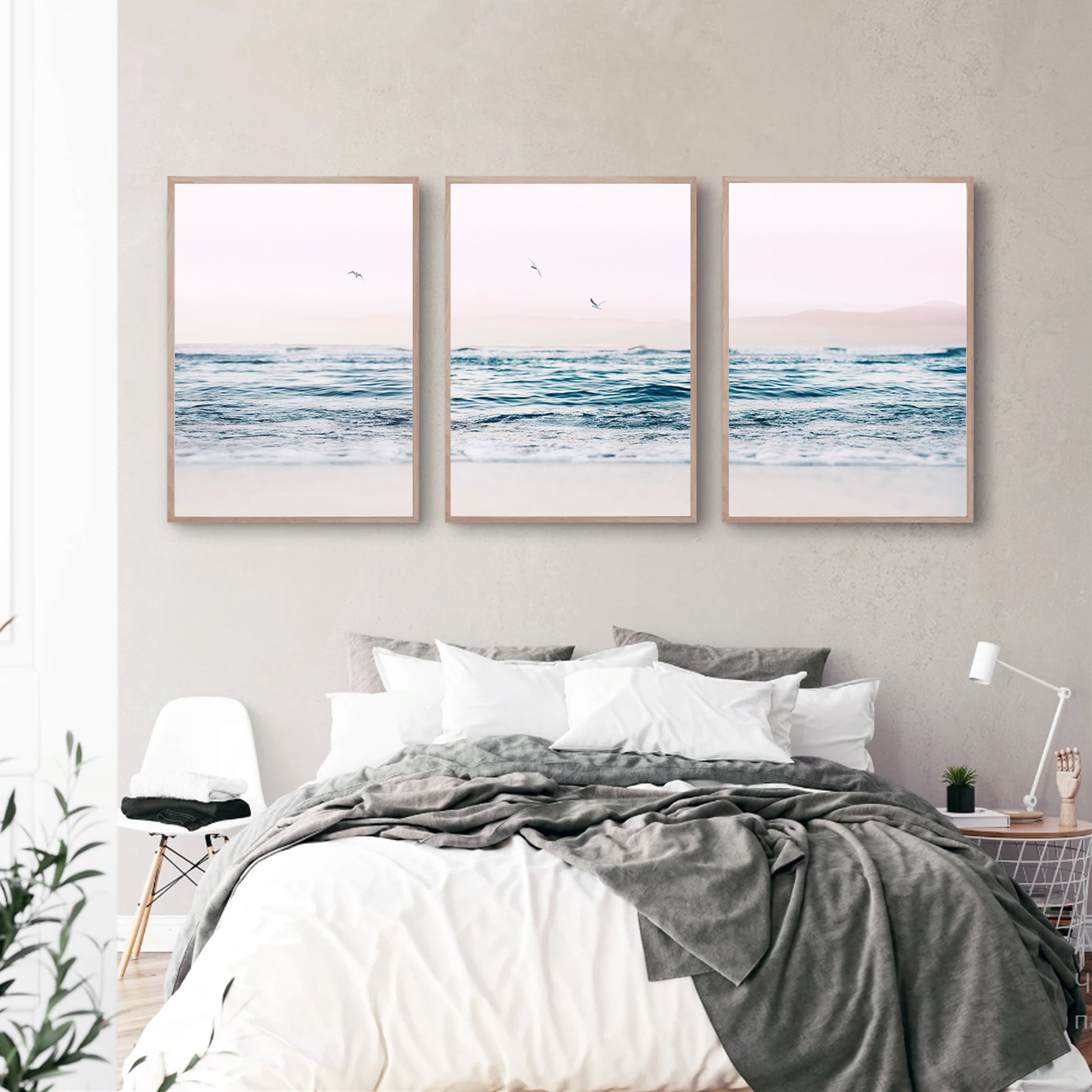 Ocean wall art in pink and blue in bedroom.