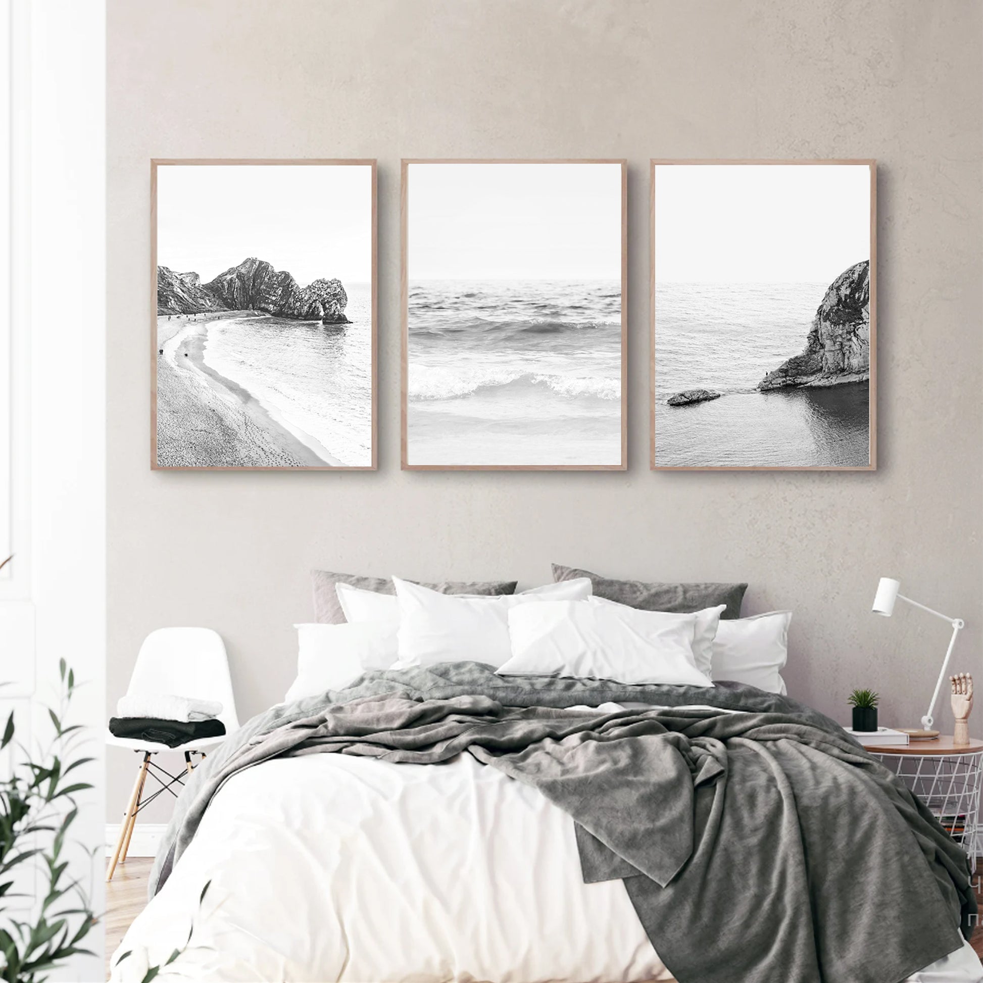 Black and white ocean wall art in bedroom.