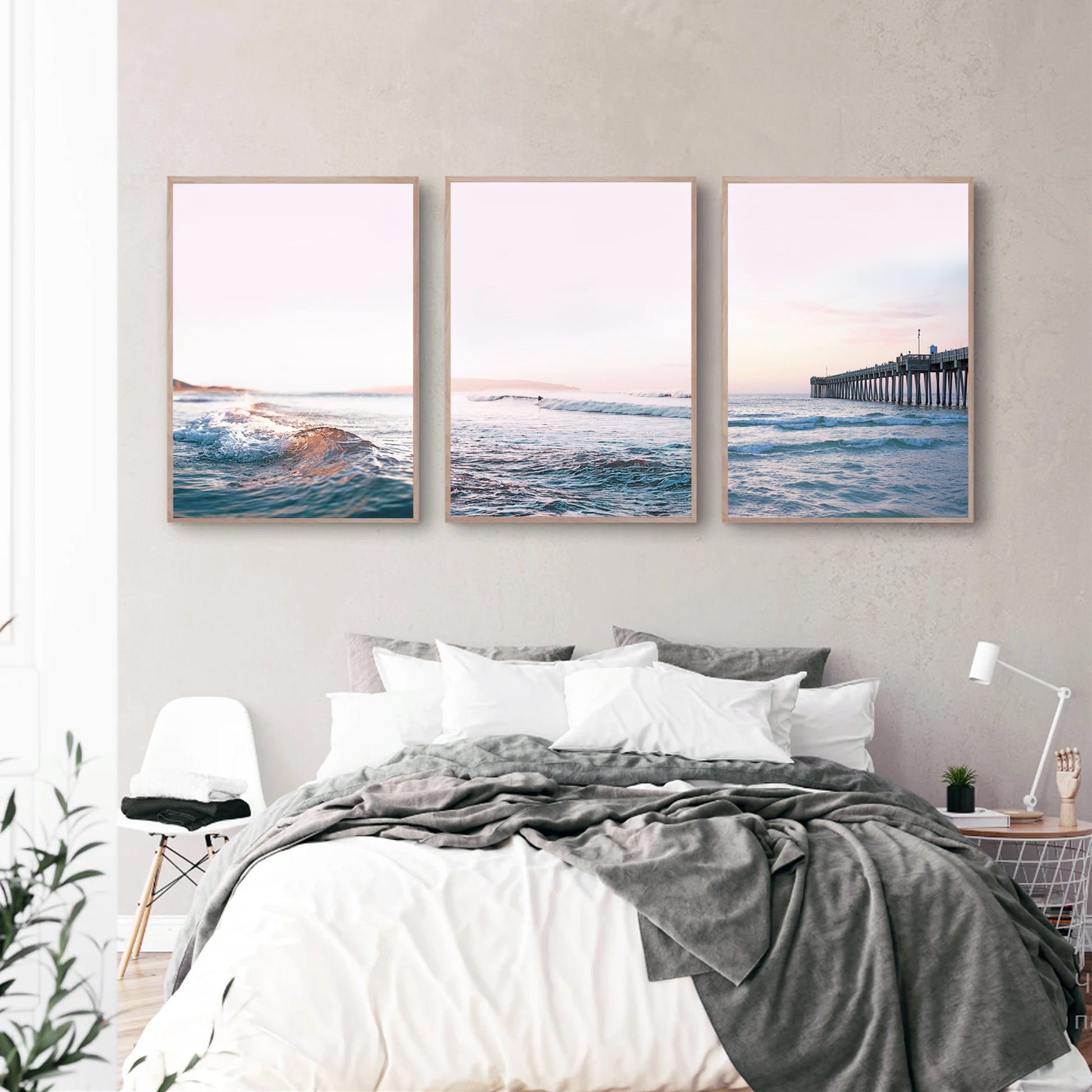 Ocean sunset triptych in wood color frames in the bedroom.