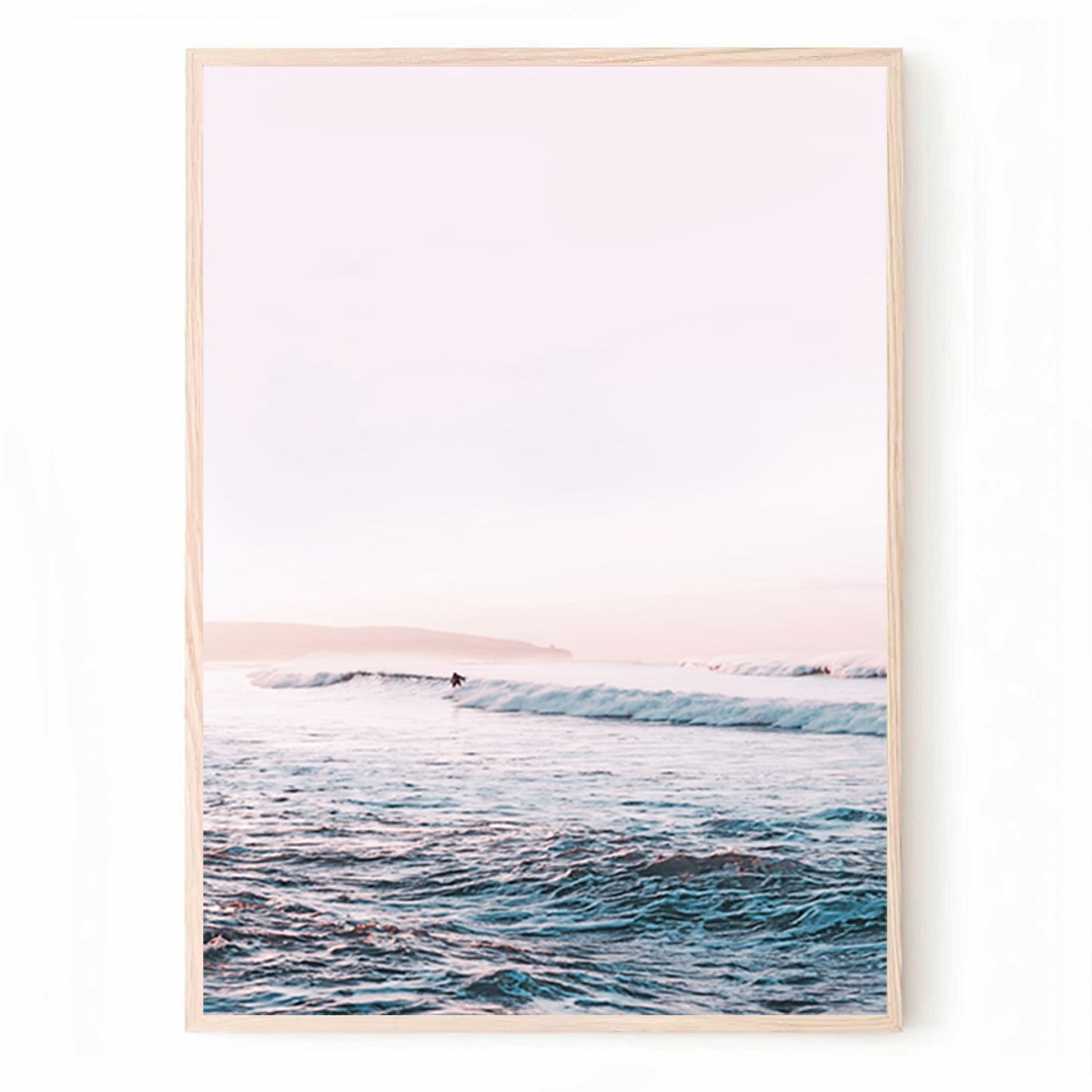 Surfer in coastal waves at sunset.