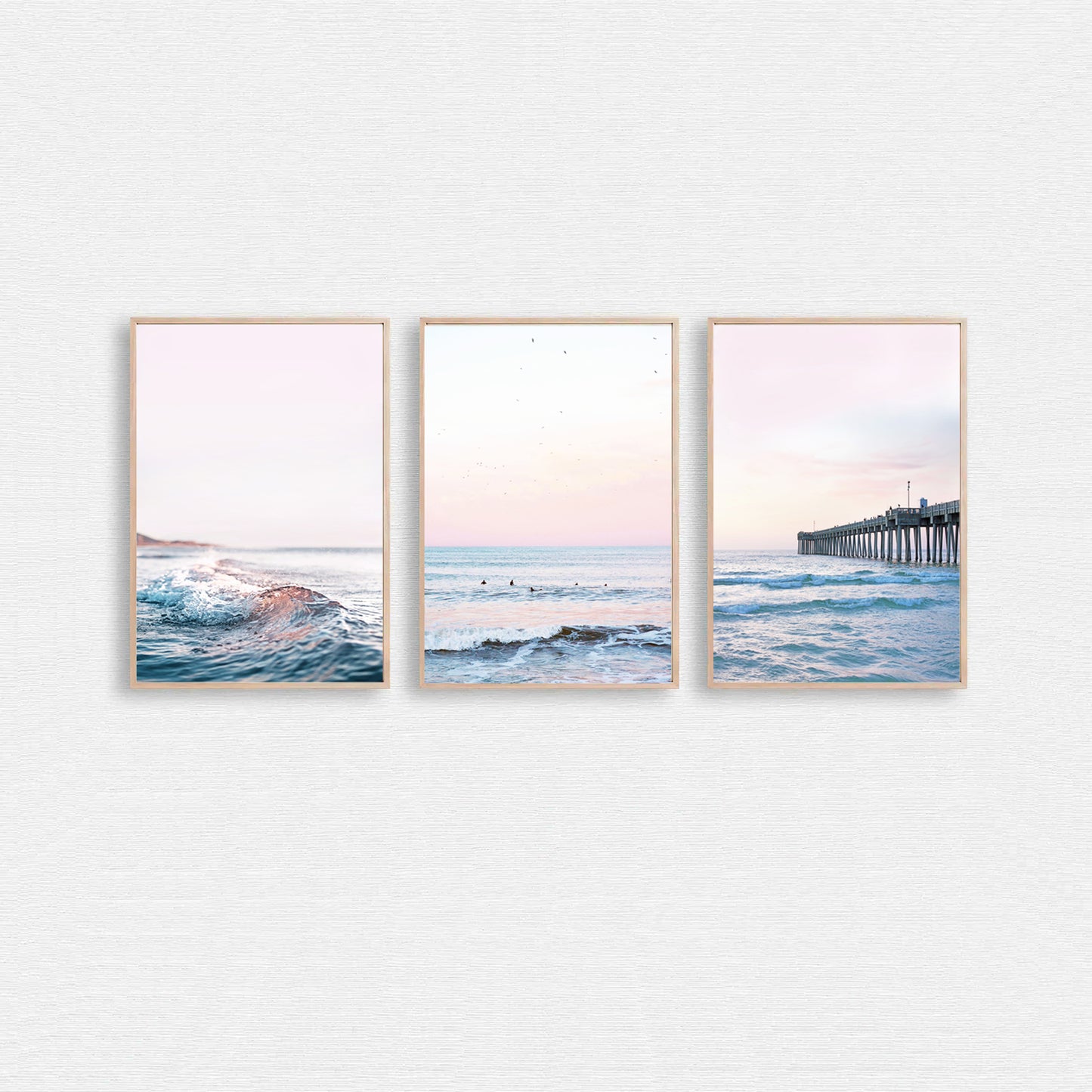 Ocean shore photo set with surfers and pier in pink and blue.