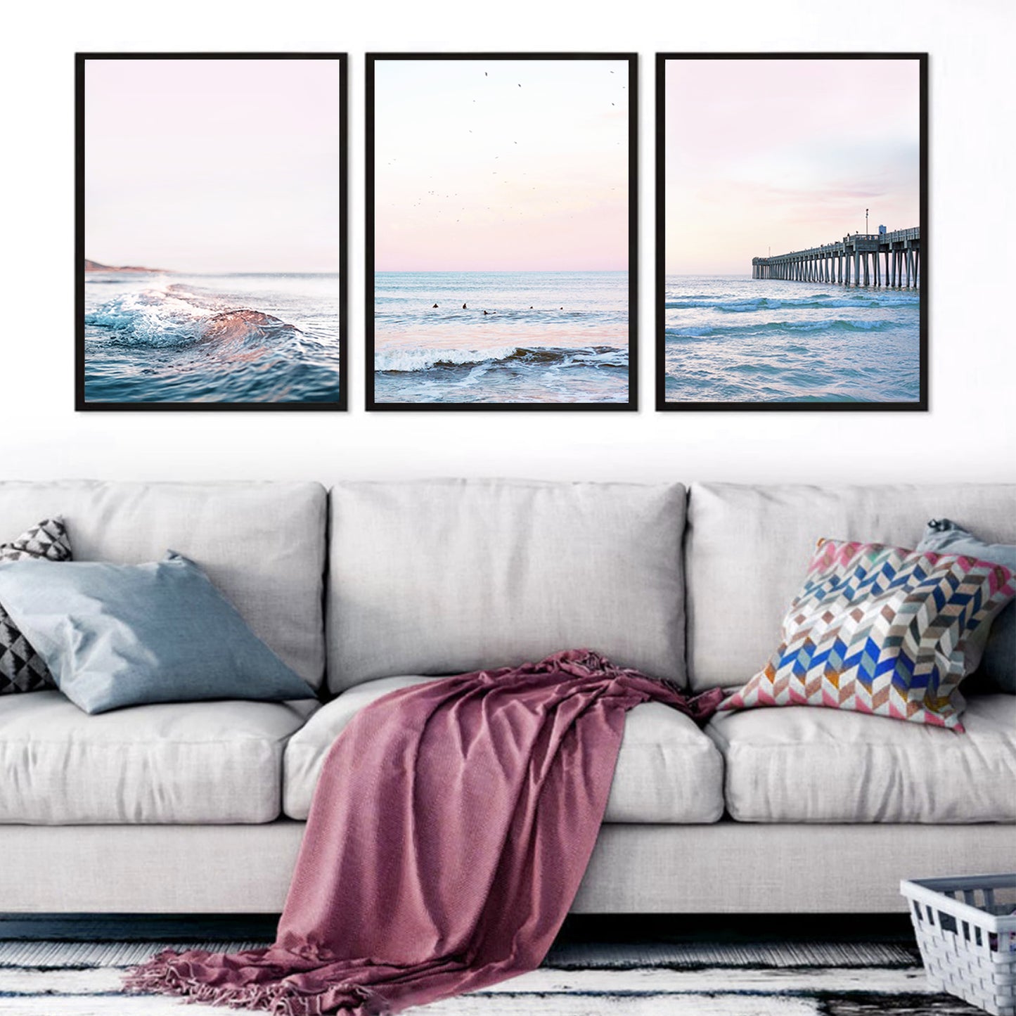 Coastal triptych wall art above the sofa.