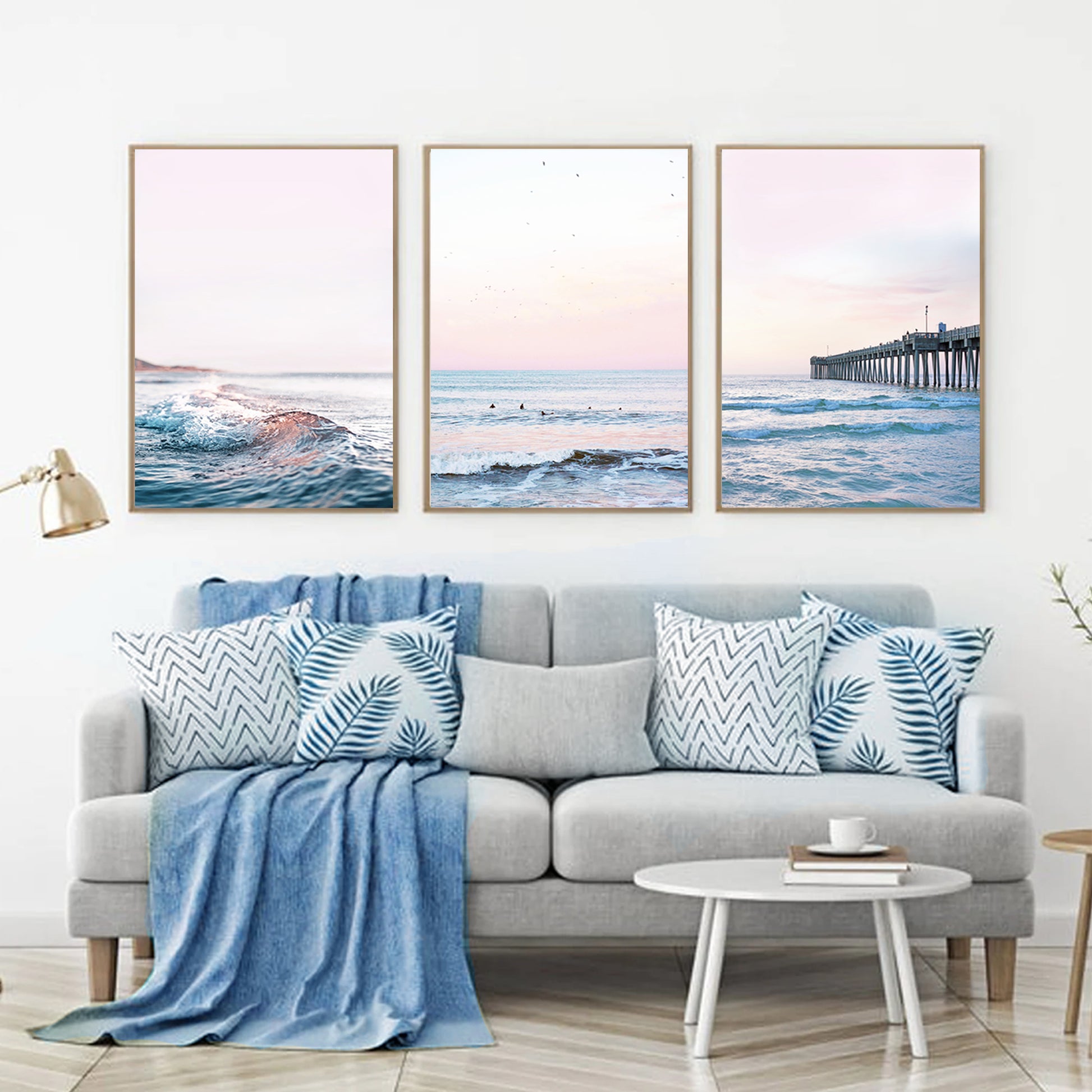 Coastal triptych wall art in pink and blue in living room.