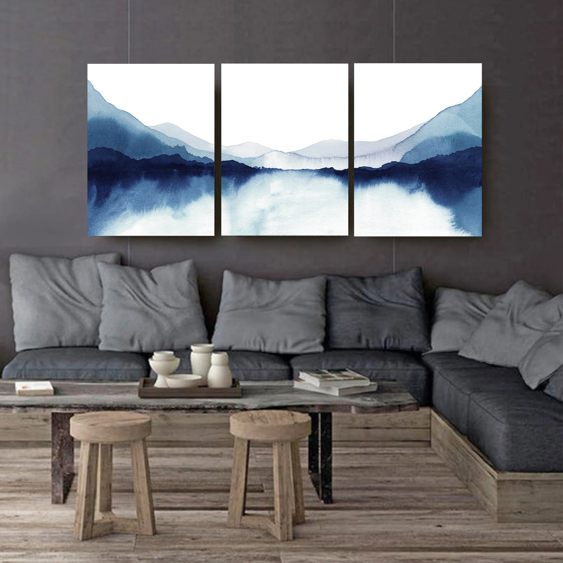 Watercolor lake stretched canvas triptych against a dark wall.