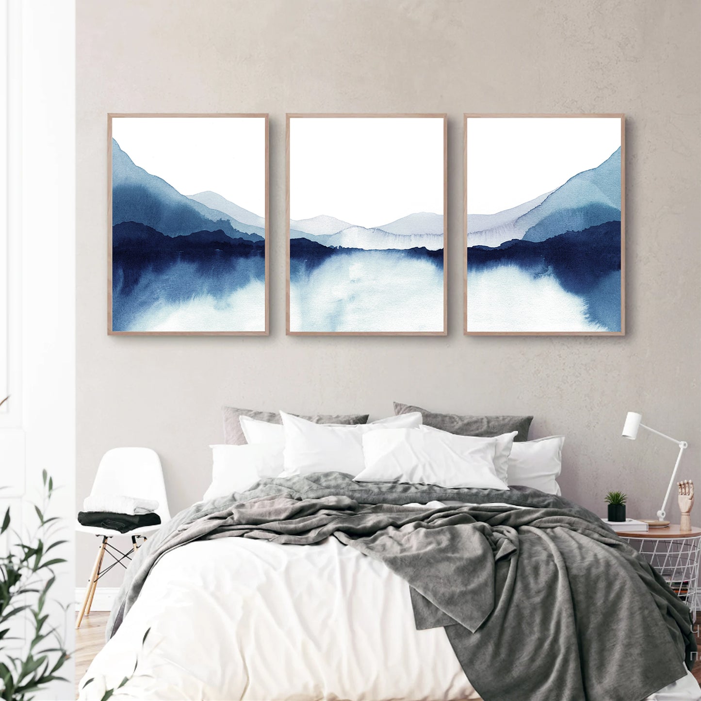 Watercolor lake triptych in the bedroom.