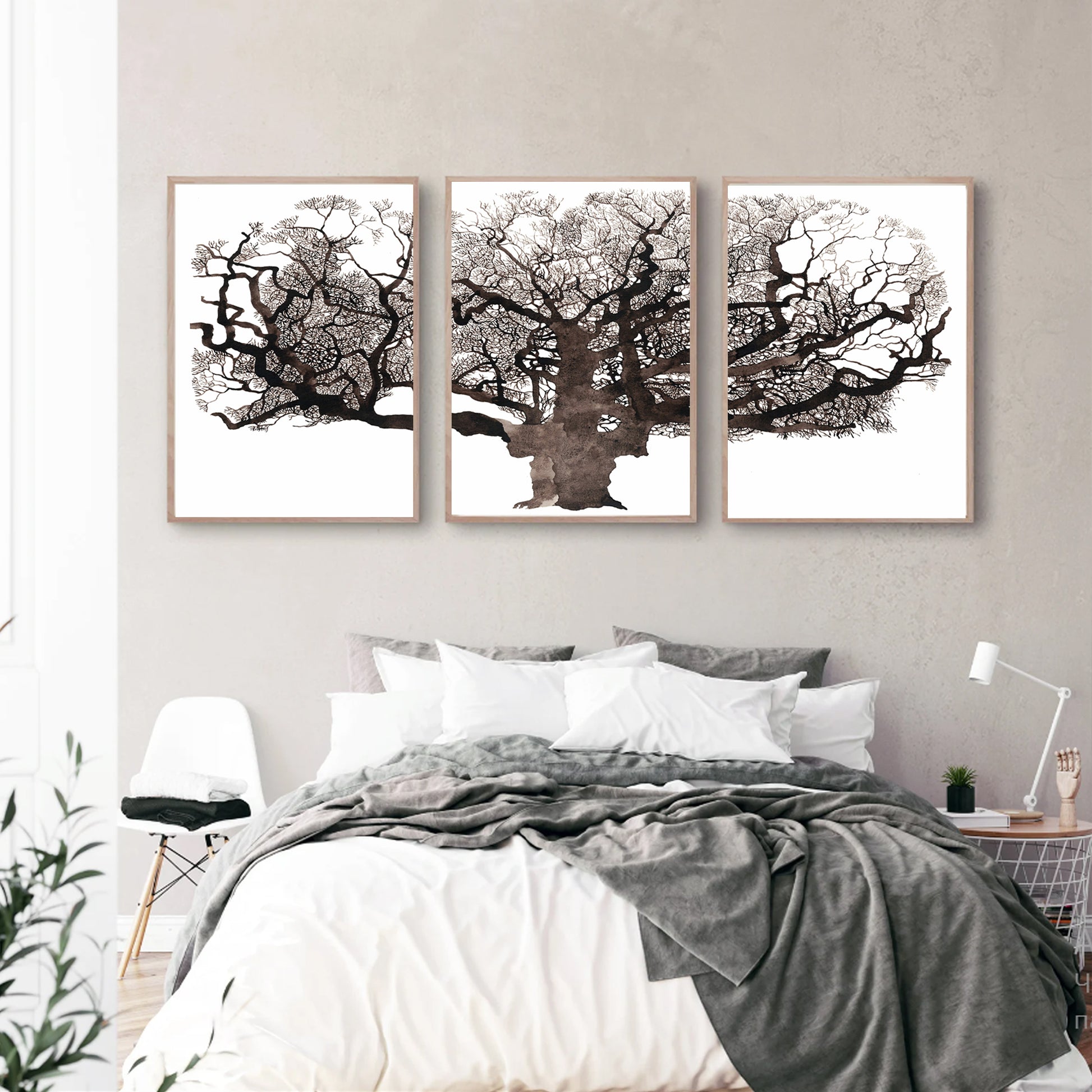 Mighty oak tree triptych in wood color frames in bedroom.