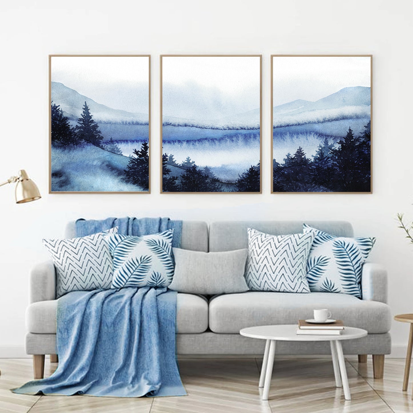 Snowy forest watercolor in wood color frames above the sofa.