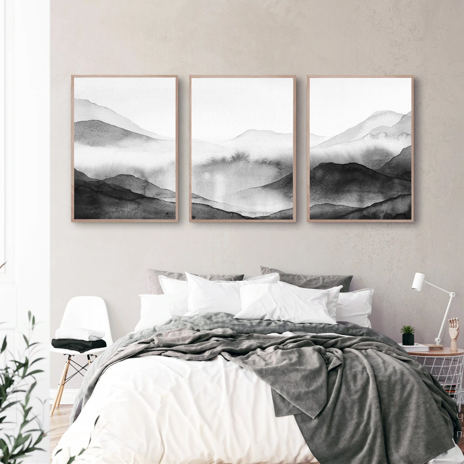 Misty mountain watercolor triptych in bedroom.